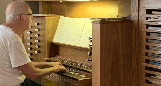 Donald Knuth plays organ at his home in Palo Alto. Photo by Petr Sojka