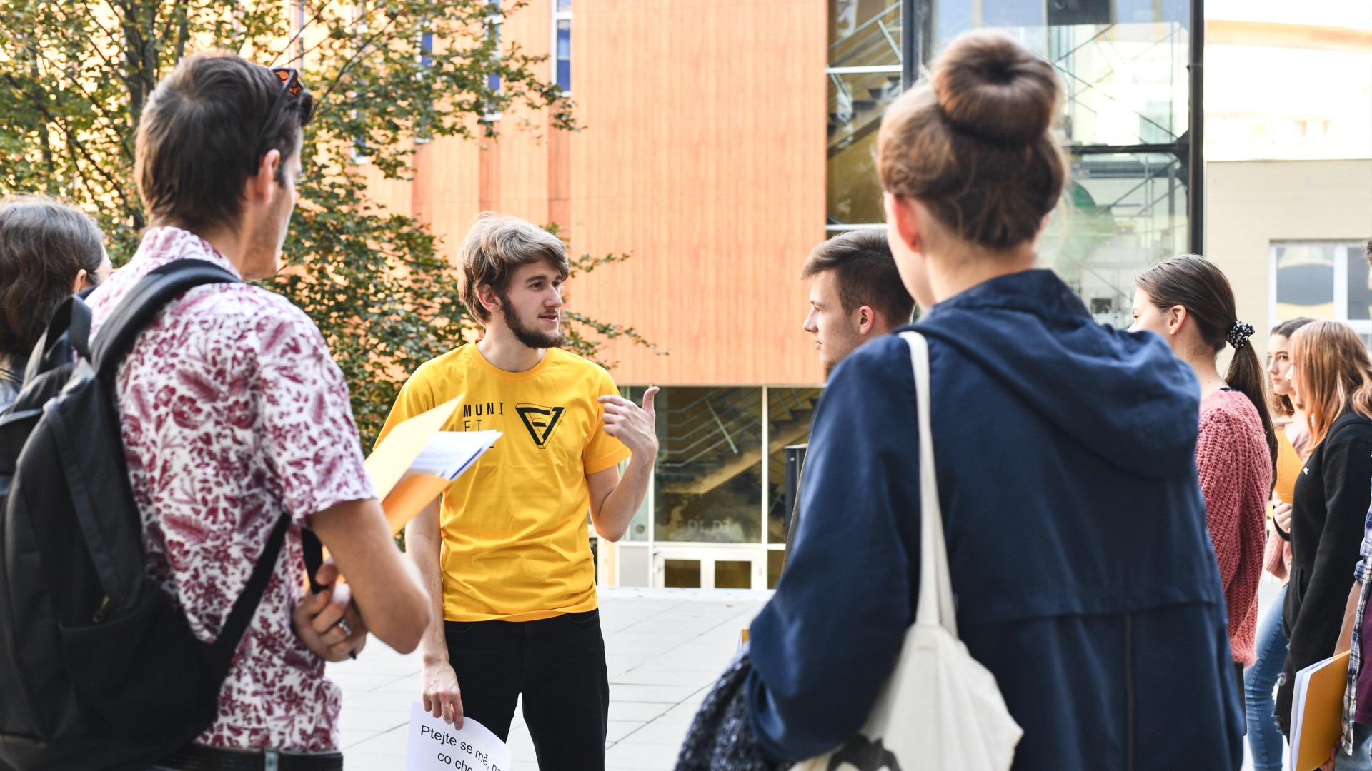 An ambassador standing in a circle answering questions