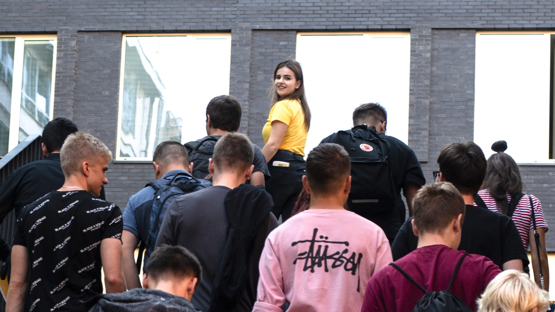 A group of attendees moving through the courtyard