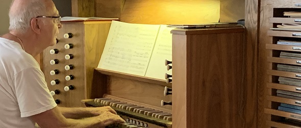 Donald Knuth plays organ at his home in Palo Alto. Photo by Petr Sojka